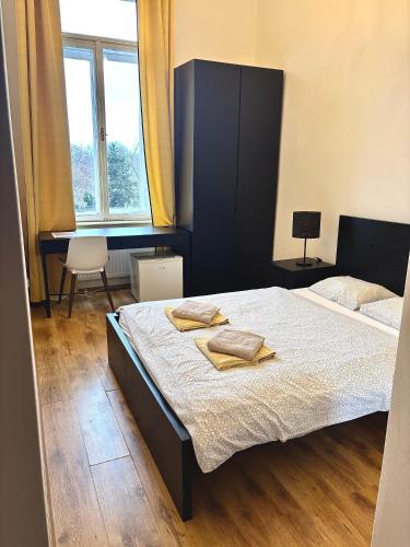 a bedroom with a bed with two towels on it at Apartment Belveder Brno in Brno