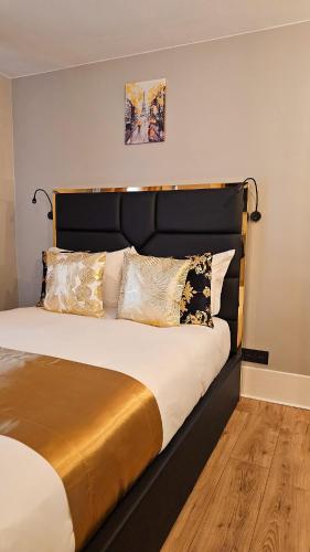 - une chambre avec un lit doté d'une tête de lit et d'oreillers noirs dans l'établissement Paris Sacré Cœur Arev Sur les pas d Emily in Paris, à Paris