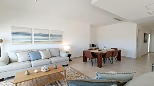 a living room with a couch and a table at Costa Divina A2 by Kivoya in La Choya