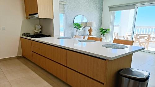 a kitchen with a island with a counter top at Costa Divina A2 by Kivoya in La Choya
