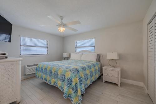 a bedroom with a bed and a ceiling fan at Coastal Waters in New Smyrna Beach