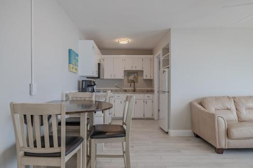 a kitchen with a table and chairs and a couch at Coastal Waters in New Smyrna Beach
