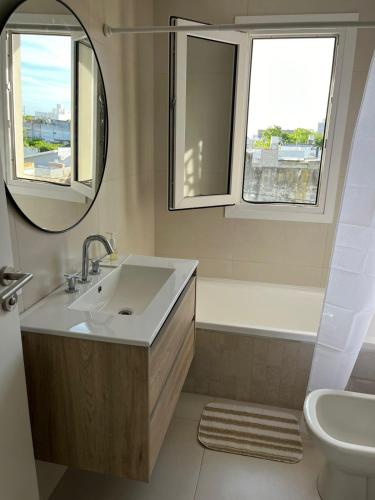 a bathroom with a sink and a mirror at Alquiler depto olavarria in Olavarría