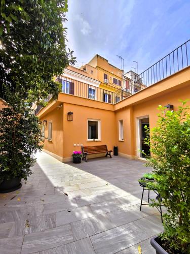 a courtyard with a bench in front of a building at Major House - Luxury Apartments in Rome by Hostand in Rome
