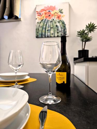 a table with two glasses and a bottle of wine at Major House - Luxury Apartments in Rome by Hostand in Rome