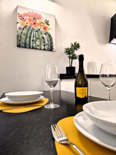 a table with two glasses and a bottle of wine at Major House - Luxury Apartments in Rome by Hostand in Rome