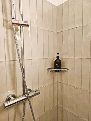 a shower with a soap bottle on a shelf in a bathroom at Major House - Luxury Apartments in Rome by Hostand in Rome