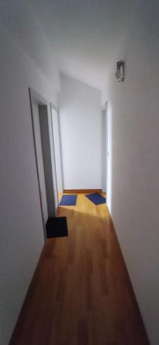 an empty room with two doors and a wooden floor at Quarto privado 6 in Famões