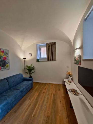 a living room with a blue couch and a tv at Major House - Luxury Apartments in Rome by Hostand in Rome