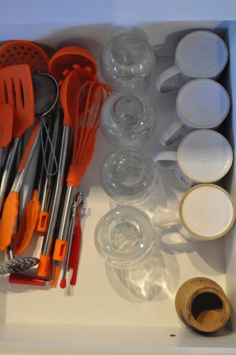 a drawer filled with glasses and other kitchen utensils at Aparts Merkaba in El Chalten