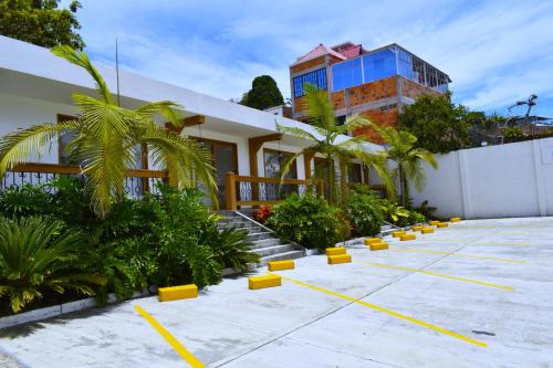a building with a bunch of plants in a parking lot at Hotel Gran Plaza San Agustin in San Agustín