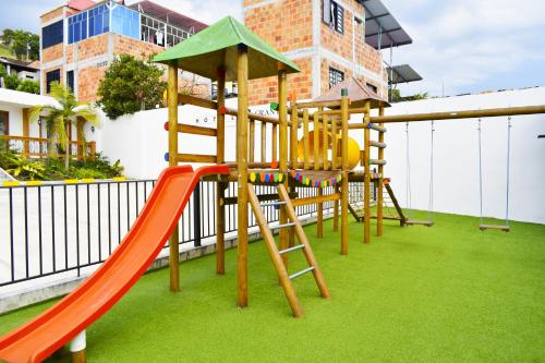 a playground with a slide and a slideintend at Hotel Gran Plaza San Agustin in San Agustín
