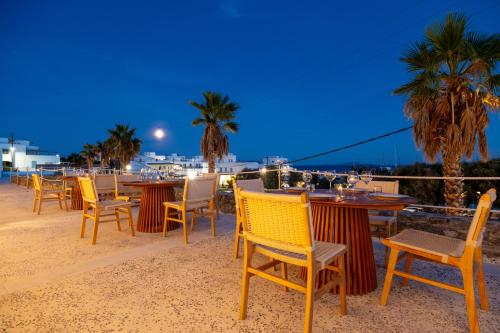 a group of tables and chairs on the beach at Cavo Piso Livadi in Piso Livadi