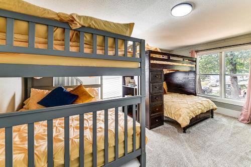 a bedroom with two bunk beds and a window at Near Campus and Casino Family-Friendly Durant Home! in Durant