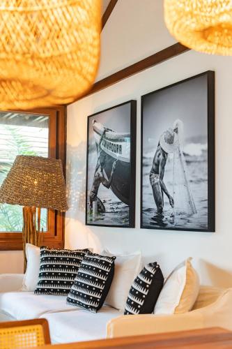 a living room with three framed pictures on the wall at Colibri Beach Villas in Ilha de Boipeba
