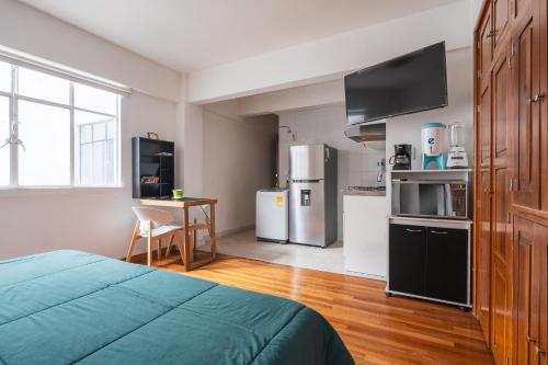 a bedroom with a bed and a kitchen with appliances at Nice private studio. Polanco area :) in Mexico City