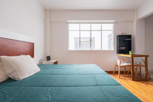 a bedroom with a large green bed and a desk at Nice private studio. Polanco area :) in Mexico City