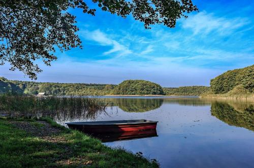a boat sitting on the shore of a lake at Urlaub im Grünen - Schmiede Blücherhof in Blücherhof
