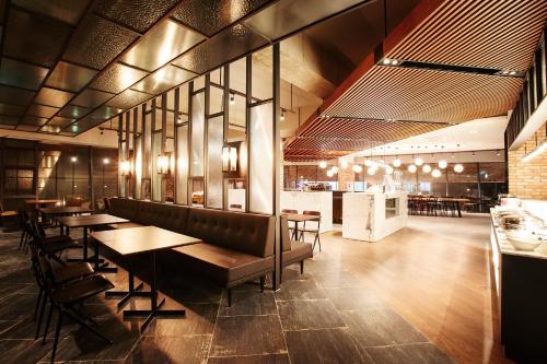 a restaurant with tables and chairs and a bar at MD HOTEL Dongtan in Hwaseong