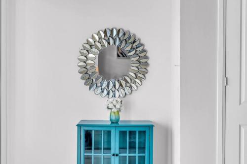 a mirror on top of a blue cabinet at Executive Brand New House 5 Bedrooms and Office in Cambridge