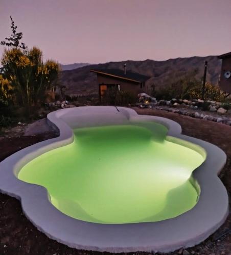 a large green object in the middle of a yard at ArribadelValle - Casas de Altura in Potrerillos