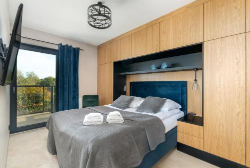 Ένα ή περισσότερα κρεβάτια σε δωμάτιο στο Apartament Dune - frontowy widok na morze w Gardenia