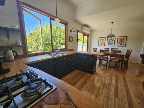 a kitchen with a stove top oven in a room at RoseIris Cottage - City Charm in Central West Hobart in West Hobart