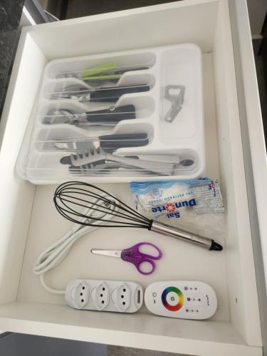 a drawer full of kitchen utensils in a refrigerator at Sobrado novo e lindo com piscina in São José dos Campos