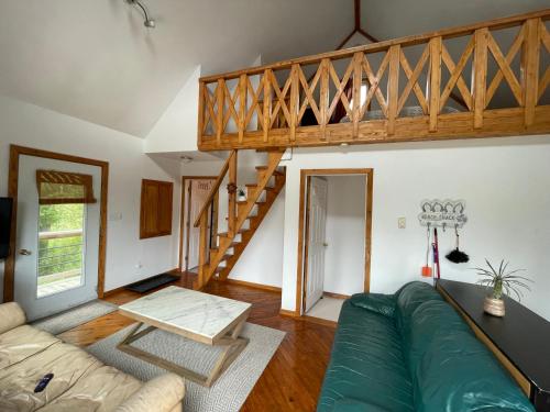 a living room with a couch and a stair case at Cozy seaside cottage in Saint Andrews