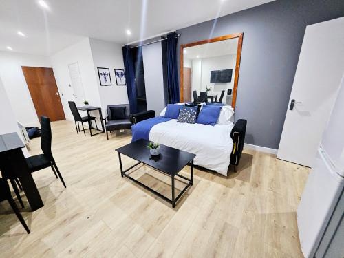 a bedroom with a bed and a table and chairs at GDY1 - The Green Dragon Apartment in London