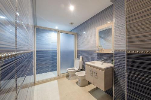 a bathroom with a toilet and a sink and a mirror at Charming City Getaway in Marrakech