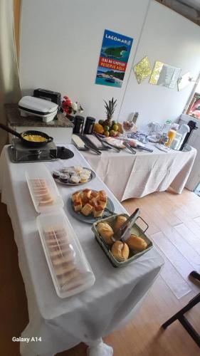 a table with several plates of food on it at GH Canal da Barra in Florianópolis