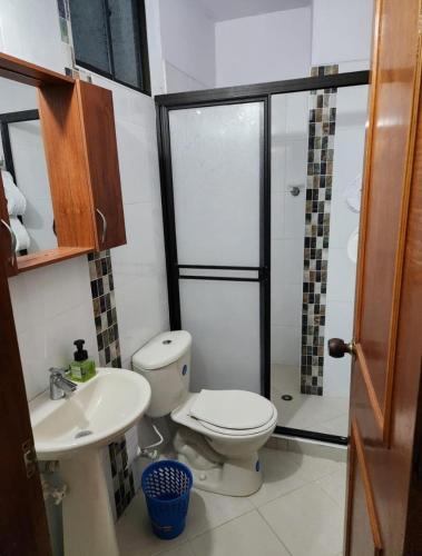 a bathroom with a toilet and a sink and a shower at Restaurante Saman in Santa Fe de Antioquia