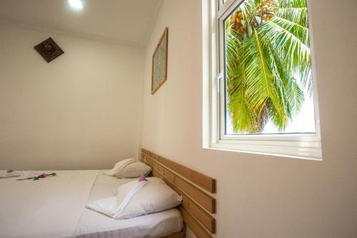 Postel nebo postele na pokoji v ubytování Faza View Inn, Maafushi