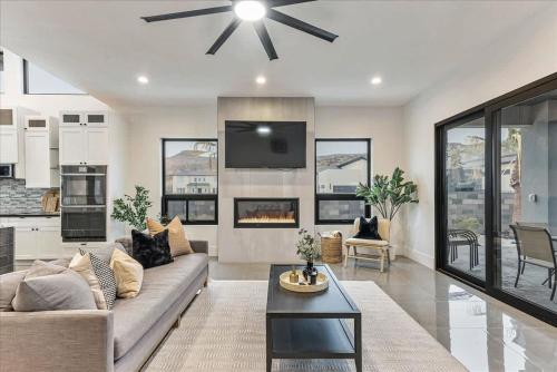 a living room with a couch and a fireplace at By Sand Hollow Rooftop Patio & Private Hot Tub in Hurricane