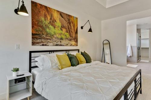 a bedroom with a large white bed with yellow pillows at Private HotTub By Copper Rock Golf Course in Hurricane