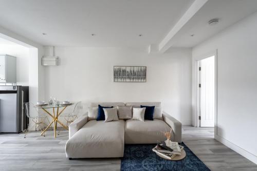 a living room with a couch and a table at Cozy Downtown Apartment in Rochester
