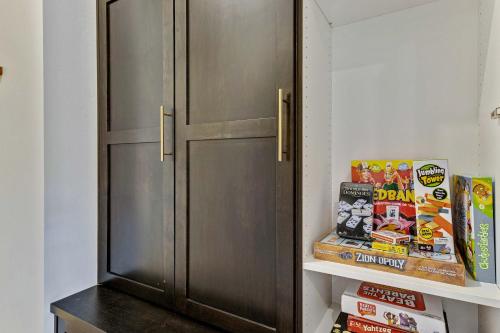 a refrigerator in a kitchen with a shelf with books at Private HotTub By Copper Rock Golf Course in Hurricane