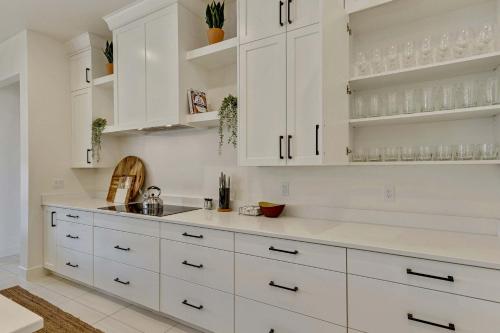a white kitchen with white cabinets and a counter at Private HotTub By Copper Rock Golf Course in Hurricane