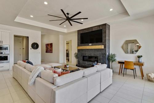 a living room with a large couch and a fireplace at Private HotTub By Copper Rock Golf Course in Hurricane