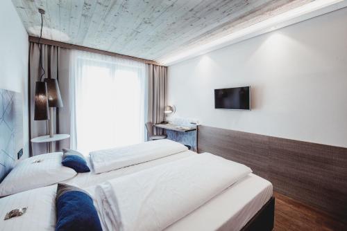 Postel nebo postele na pokoji v ubytování arte Hotel Kufstein