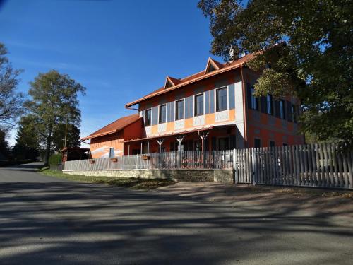 a large building with a fence in front of it at Vlčí Jámy in Lenora