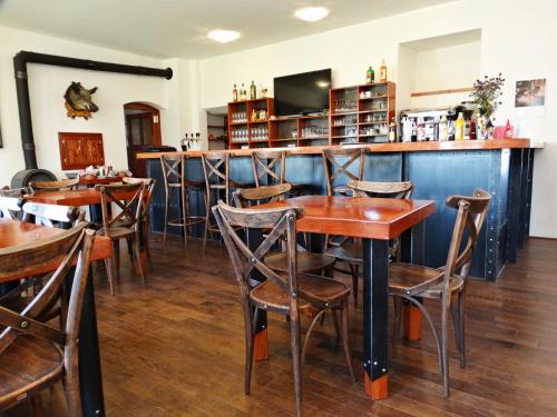 a bar with wooden tables and chairs in a restaurant at Vlčí Jámy in Lenora