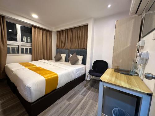 a hotel room with a bed and a tv at SS Grey Hotel Bukit Bintang in Kuala Lumpur