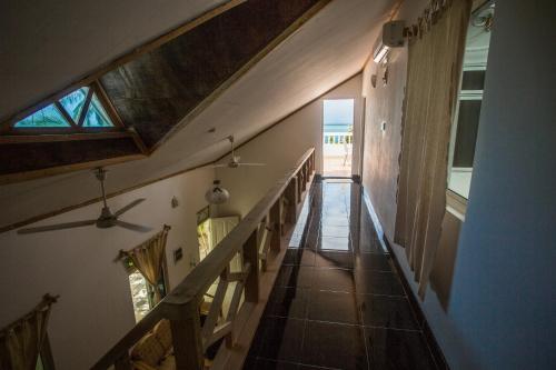 a hallway of a house with stairs and a window at Faza View Inn, Maafushi in Maafushi