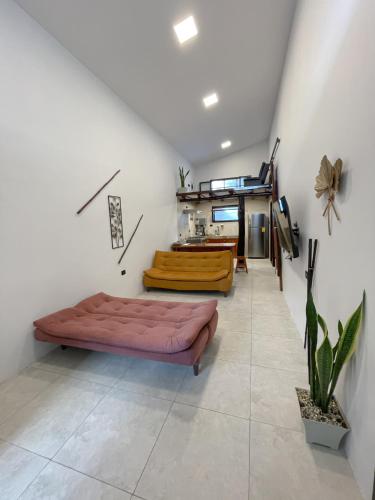 a living room with a bed and a table at Casa Vacacional en Santa Cruz in Puerto Ayora