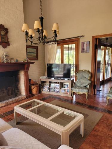 a living room with a coffee table and a fireplace at Casa con piscina en Piriápolis in Piriápolis