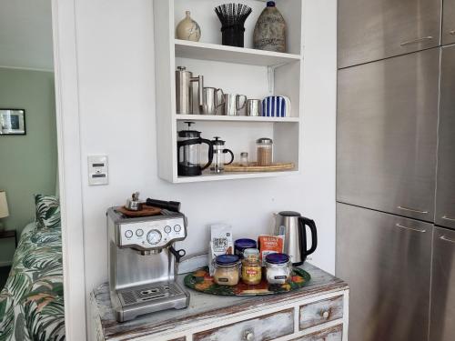 a kitchen with a counter with a coffee maker on it at Coromandel Eco Sanctuary in Coromandel Town