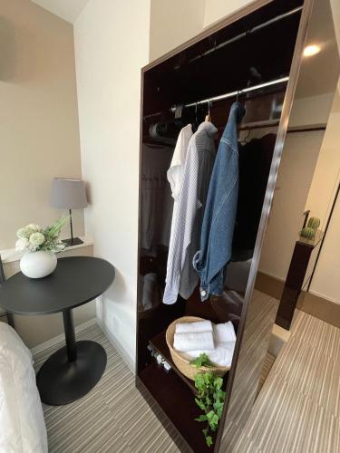 a closet with a mirror and a table in a room at COMMA HOUSE Shinjuku 13 in Tokyo