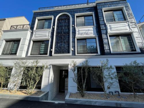 a black and white building with a large window at COMMA HOUSE Shinjuku 13 in Tokyo